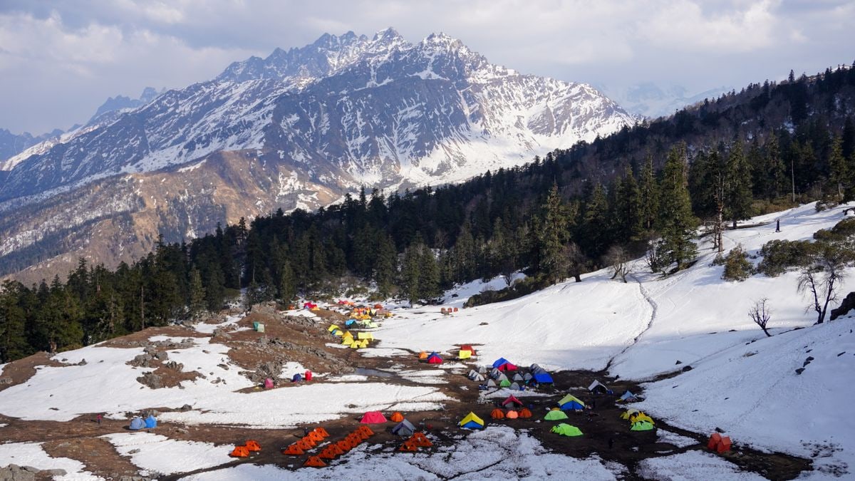 Explore the snowy mountains and colorful tents in Salud Dugra, Uttarakhand.